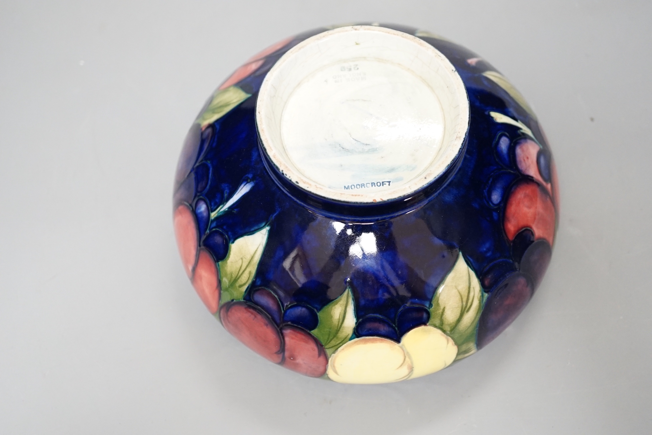 A Moorcroft Wisteria pattern bowl - 18cm wide